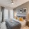 Large well lit bedroom with plush carpets and large windows 