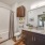 Large well lit bathroom with white accents 
