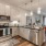 Model kitchen at our apartments for rent in Grapevine, TX, featuring wood grain flooring and stainless steel appliances.