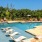 The pool area at our apartments in Grapevine, TX, featuring beach chairs, umbrellas, and a view of the trees.
